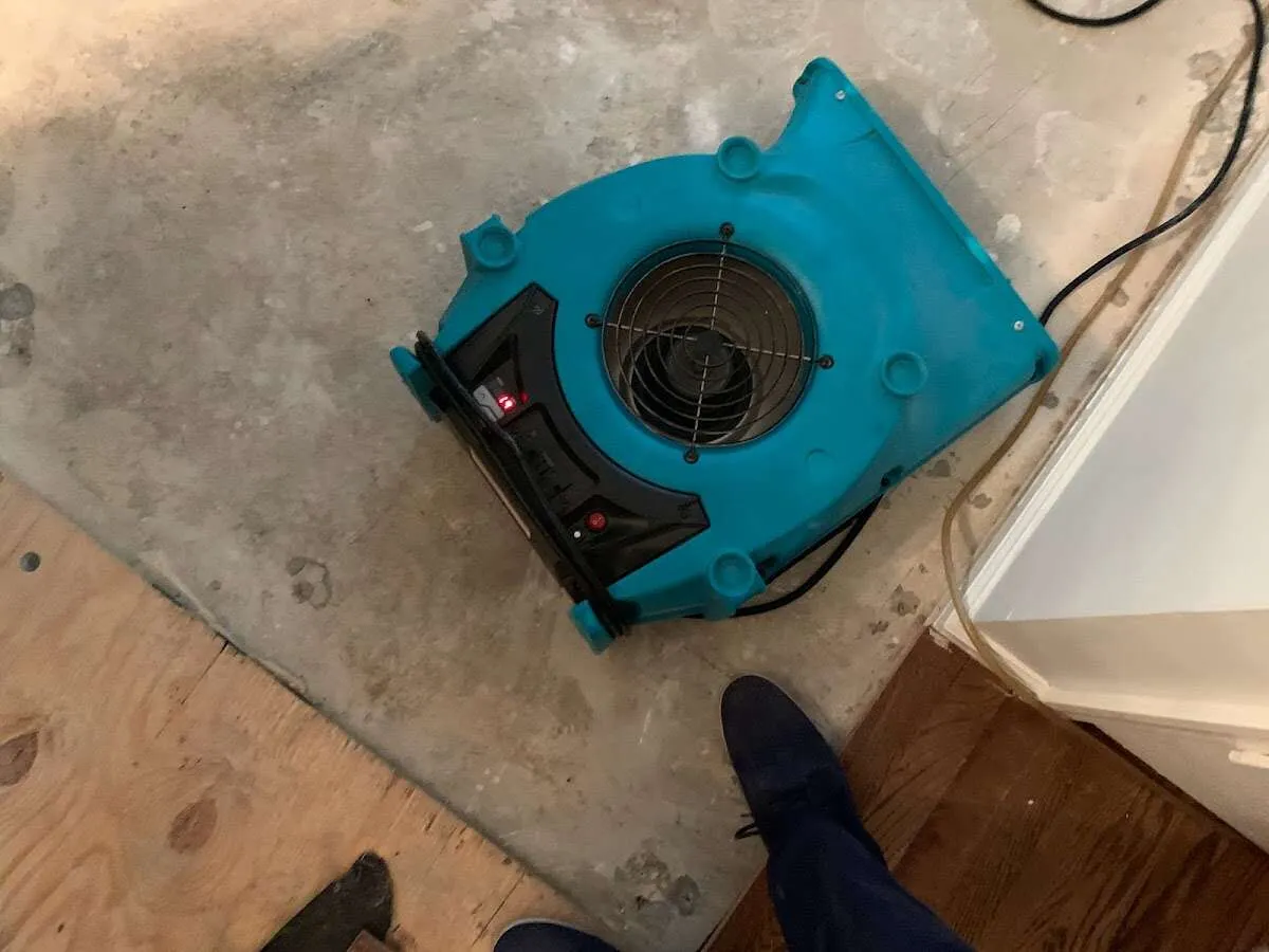 Air mover drying subfloor during Commercial Water Damage Restoration in Harvey